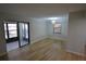Spacious living room with a sliding door to the enclosed lanai and a window at 3399 Mermoor Dr # 110, Palm Harbor, FL 34685