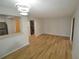 This living room boasts wood flooring and features a unique, circular light fixture and built in washer and dryer at 3399 Mermoor Dr # 110, Palm Harbor, FL 34685