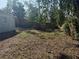 Spacious backyard with a mix of grass and natural landscaping, providing room for outdoor activities and relaxation at 3406 N 48Th St, Tampa, FL 33605