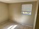 Bedroom featuring one window with white blinds and tile flooring at 3406 N 48Th St, Tampa, FL 33605