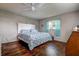 Bright bedroom features a white headboard and blue patterned quilt at 3550 100Th N Pl, Pinellas Park, FL 33782
