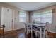 Bright dining room with plenty of natural light, a dining table, and wood-look floors at 3550 100Th N Pl, Pinellas Park, FL 33782