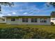 Well-maintained one-story home with ample windows offering natural light and a lush green lawn at 3550 100Th N Pl, Pinellas Park, FL 33782