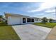 Single story home with an attached garage and a well manicured lawn at 3550 100Th N Pl, Pinellas Park, FL 33782
