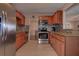 Modern kitchen featuring stainless steel appliances, tile backsplash, and wood cabinets at 3550 100Th N Pl, Pinellas Park, FL 33782