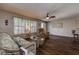 Open-concept living area with comfortable seating and a ceiling fan at 3550 100Th N Pl, Pinellas Park, FL 33782