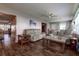 Cozy living room with ceiling fan, wood-look flooring, and comfortable seating at 3550 100Th N Pl, Pinellas Park, FL 33782