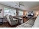 Relaxing living room with plush seating, natural light, and a ceiling fan at 3550 100Th N Pl, Pinellas Park, FL 33782