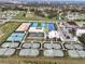 Aerial view of extensive sports facilities, including multiple tennis courts and parking at 36419 Garden Wall Way, Zephyrhills, FL 33541