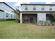Backyard with a screened in patio, and lush green lawn at 36419 Garden Wall Way, Zephyrhills, FL 33541