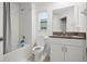 Modern bathroom features a shower-tub combination and a granite-topped vanity, adding a touch of elegance at 36419 Garden Wall Way, Zephyrhills, FL 33541
