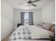 Well-lit bedroom with a ceiling fan, window with blinds, and cozy decor and furnishings at 36419 Garden Wall Way, Zephyrhills, FL 33541