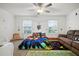 This bedroom features bright windows, fun wall decor and comfortable seating at 36419 Garden Wall Way, Zephyrhills, FL 33541