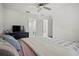 Bright bedroom featuring white walls, a ceiling fan, and an ensuite bathroom for added convenience at 36419 Garden Wall Way, Zephyrhills, FL 33541