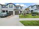 Front exterior showcasing townhome with blue grey color, 1 car garage and landscaping at 36419 Garden Wall Way, Zephyrhills, FL 33541