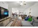 Open-concept living room with a ceiling fan and lots of natural light at 36419 Garden Wall Way, Zephyrhills, FL 33541
