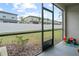 Screened patio overlooking backyard with a vinyl fence at 36419 Garden Wall Way, Zephyrhills, FL 33541