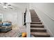 Carpeted staircase leading to the upper level, bathed in natural light at 36419 Garden Wall Way, Zephyrhills, FL 33541