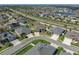 A stunning aerial view showcases this home's prime location within a well-planned community with mature landscaping at 4043 Salida Del Sol Dr, Sun City Center, FL 33573