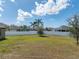 Large backyard with meticulously maintained lawn and white vinyl privacy fence at 4043 Salida Del Sol Dr, Sun City Center, FL 33573