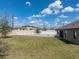Spacious backyard featuring a manicured lawn, and a white vinyl fence at 4043 Salida Del Sol Dr, Sun City Center, FL 33573