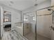 Modern bathroom with glass shower, soaking tub, and wood-look tile flooring at 4043 Salida Del Sol Dr, Sun City Center, FL 33573