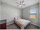 Cozy bedroom featuring a ceiling fan, plush carpet, and a comfortable bed with decorative pillows at 4043 Salida Del Sol Dr, Sun City Center, FL 33573