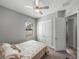 Neutral bedroom with closet, ceiling fan, window, carpet, and a comfortable bed with decorative pillows at 4043 Salida Del Sol Dr, Sun City Center, FL 33573