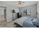 Bedroom features wood-look tile, ceiling fan, and safe on shelving unit at 4043 Salida Del Sol Dr, Sun City Center, FL 33573