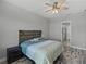Bedroom featuring rustic headboard, wood-look tile floors, and ensuite bathroom at 4043 Salida Del Sol Dr, Sun City Center, FL 33573