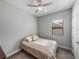 Bedroom with ceiling fan, window, carpet, and a comfortable bed with decorative pillows and adjacent dresser at 4043 Salida Del Sol Dr, Sun City Center, FL 33573