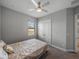 Bedroom with double door closet, ceiling fan, window, carpet, and a comfortable bed with decorative pillows at 4043 Salida Del Sol Dr, Sun City Center, FL 33573