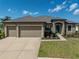 This single-story home with a three-car garage boasts well-manicured landscaping and great curb appeal at 4043 Salida Del Sol Dr, Sun City Center, FL 33573