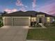 Charming single-story home with a three-car garage, fresh landscaping, and inviting curb appeal at 4043 Salida Del Sol Dr, Sun City Center, FL 33573