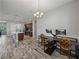 Open concept interior with kitchen island and desk space with modern wood-look floors at 4043 Salida Del Sol Dr, Sun City Center, FL 33573