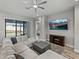 Bright living room featuring a large sectional sofa, a ceiling fan, and sliding glass doors to the backyard at 4043 Salida Del Sol Dr, Sun City Center, FL 33573