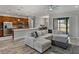 Open floor plan integrates a spacious living room and kitchen with stainless appliances and a large sectional sofa at 4043 Salida Del Sol Dr, Sun City Center, FL 33573