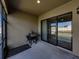 Outdoor patio featuring a grill and a large sliding glass door leading to interior of the house at 4043 Salida Del Sol Dr, Sun City Center, FL 33573