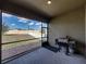 View of the covered patio with grill overlooking fenced-in backyard and brick pathway at 4043 Salida Del Sol Dr, Sun City Center, FL 33573