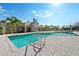 Community pool featuring clear blue water, a brick paver deck, and a cabana with lounge chairs at 4115 Brentwood Park Cir, Tampa, FL 33624