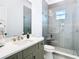 Modern bathroom with a glass-enclosed shower, a stylish vanity, and neutral color palette at 4816 W San Jose St, Tampa, FL 33629