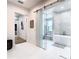 Bright bathroom features a soaking tub, mosaic tile wall, and glass barn door at 4816 W San Jose St, Tampa, FL 33629