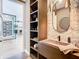 Modern powder room with a floating sink, a decorative mirror, and access to the kitchen at 4816 W San Jose St, Tampa, FL 33629
