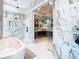 Bright bathroom features a soaking tub, marble shower, glass doors, and stylish vanity at 4816 W San Jose St, Tampa, FL 33629