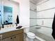 Modern bathroom features a glass-enclosed shower with mosaic tile accents and a floating vanity at 4816 W San Jose St, Tampa, FL 33629