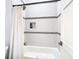 Bathroom featuring tub and shower combo with decorative accent tile at 4816 W San Jose St, Tampa, FL 33629