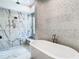 Luxurious bathroom with soaking tub, marble and mosaic tile shower, and built-in bench at 4816 W San Jose St, Tampa, FL 33629