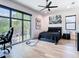 Bright bedroom features a large window, light wood floors, ceiling fan and minimalist decor at 4816 W San Jose St, Tampa, FL 33629