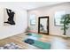 Bonus room with natural light, hardwood floors, minimalist decor, and yoga mats at 4816 W San Jose St, Tampa, FL 33629