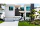Beautiful modern home exterior featuring a well-manicured lawn, an attached two-car garage, and striking design at 4816 W San Jose St, Tampa, FL 33629